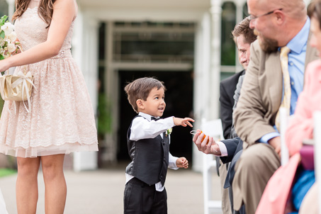 ring bearer handing out golden paper crane at the ceremony