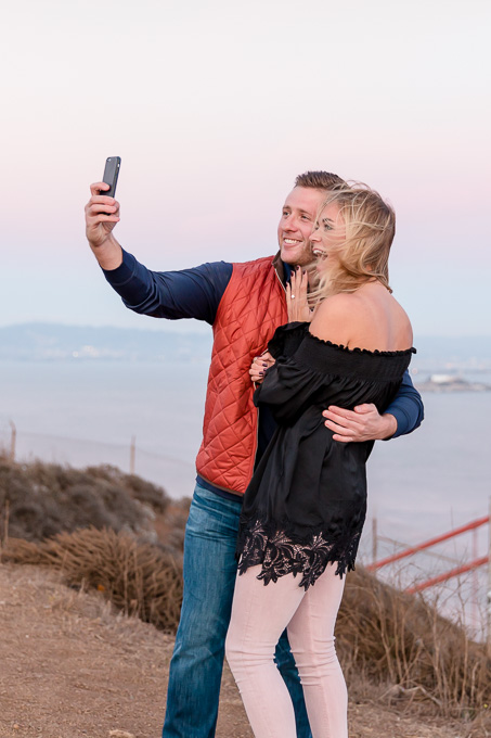 the newly engaged couple taking a cute selfie right after their SF surprise proposal