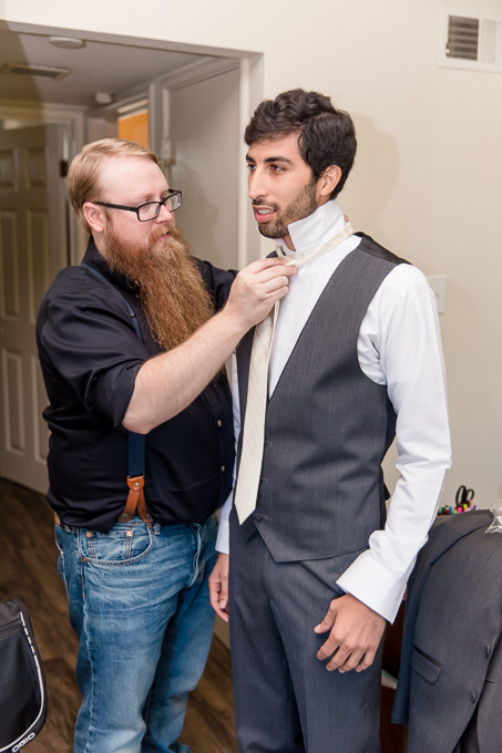 groom getting ready with the help of his best man