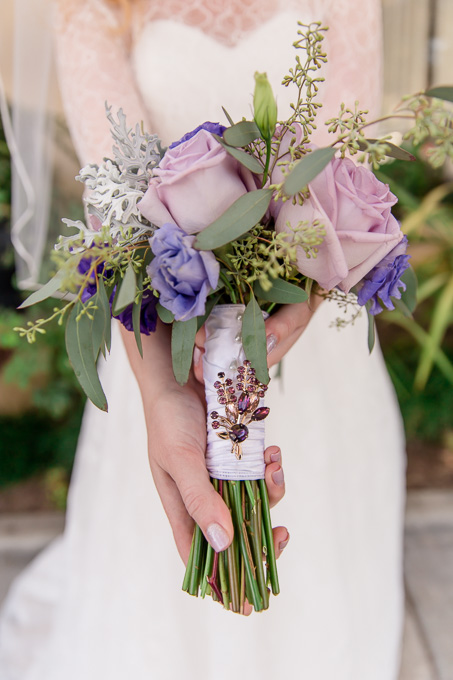 a purple crystal rhinestone brooch on the elegant lilac bridal bouquet