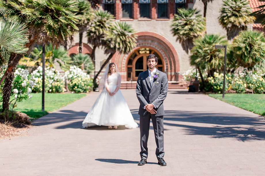 a wedding first look at San Jose State University in front of the Tower Hall