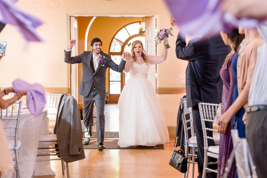 bride and groom made their grand entrance with guests cheering on them