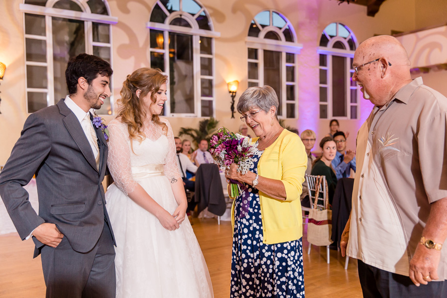 newlyweds give a bouquet to the longest married couple as a gift