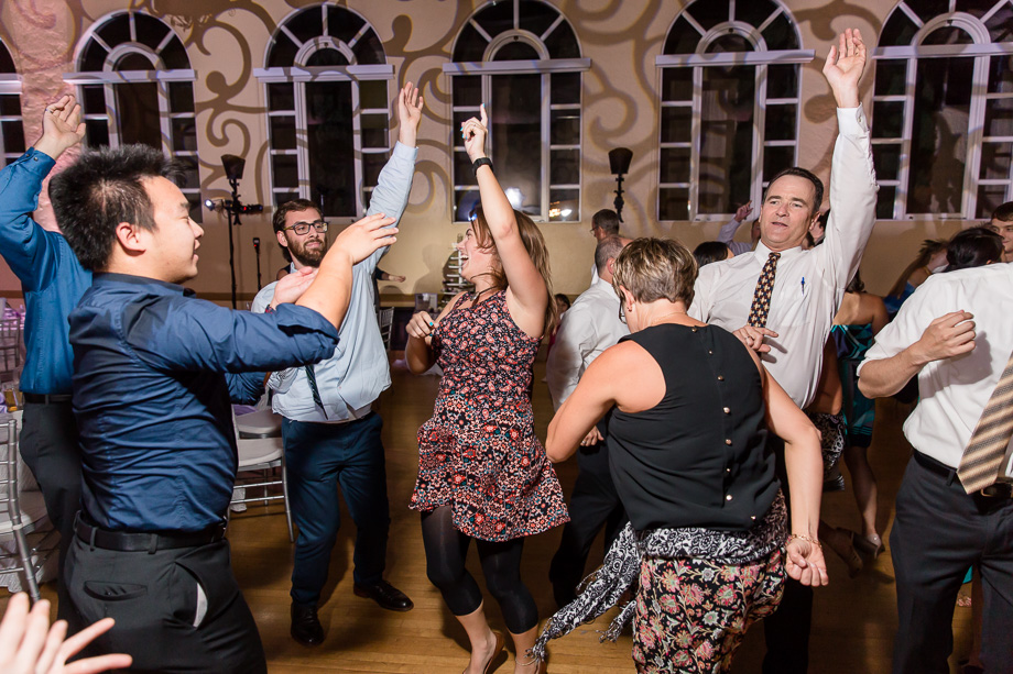 hands raised up in the air at the wedding reception dance party