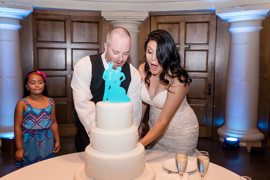 a precious and funny moment when cutting the wedding cake