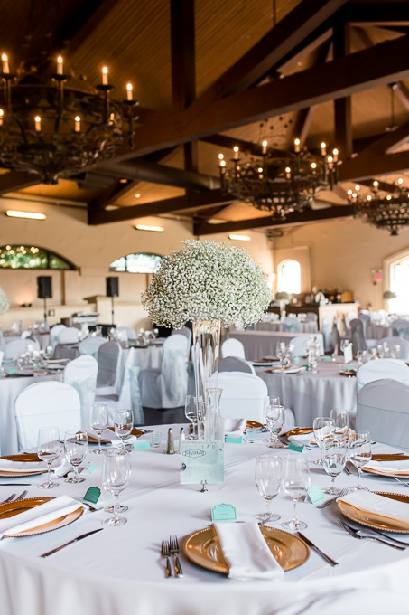 babys breath centerpieces with wood ceiling and gold plate settings