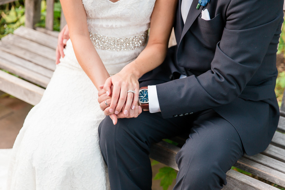 a close up of the rings and grooms watch