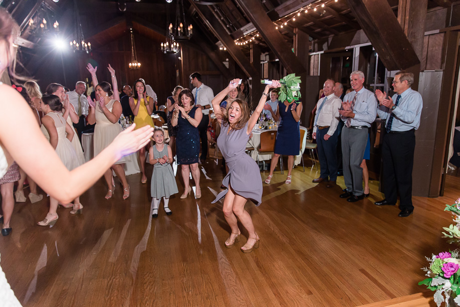 victory dance after successfully catching the tossing bouquet at a wedding reception