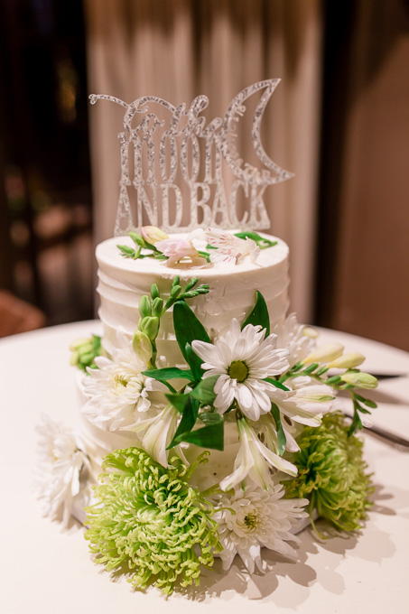 two tier pretty little wedding cake with white and green floral