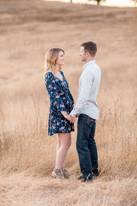 romantic save the date picture on a hilly grassy field