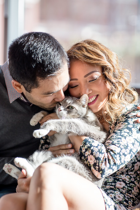 snuggle with the beloved cat for their engagement photo