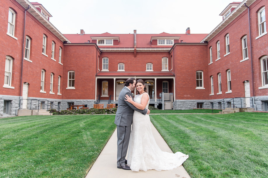 wedding portrait in front of a red brick building at San Francisco Presidio