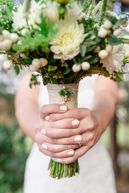 beautiful white and green bridal bouquet with a gorgeous pin