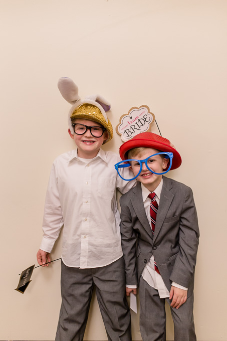 little wedding guests with fun photo booth props