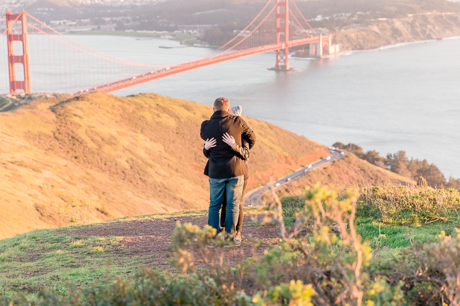 couple engaged in front of golden gate bridge