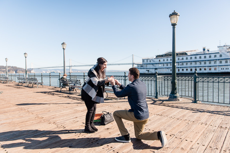 a super emotional surprise proposal on the pier overlooking San Francisco Bay Bridge