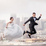 fun jumping wedding photo with bride and groom