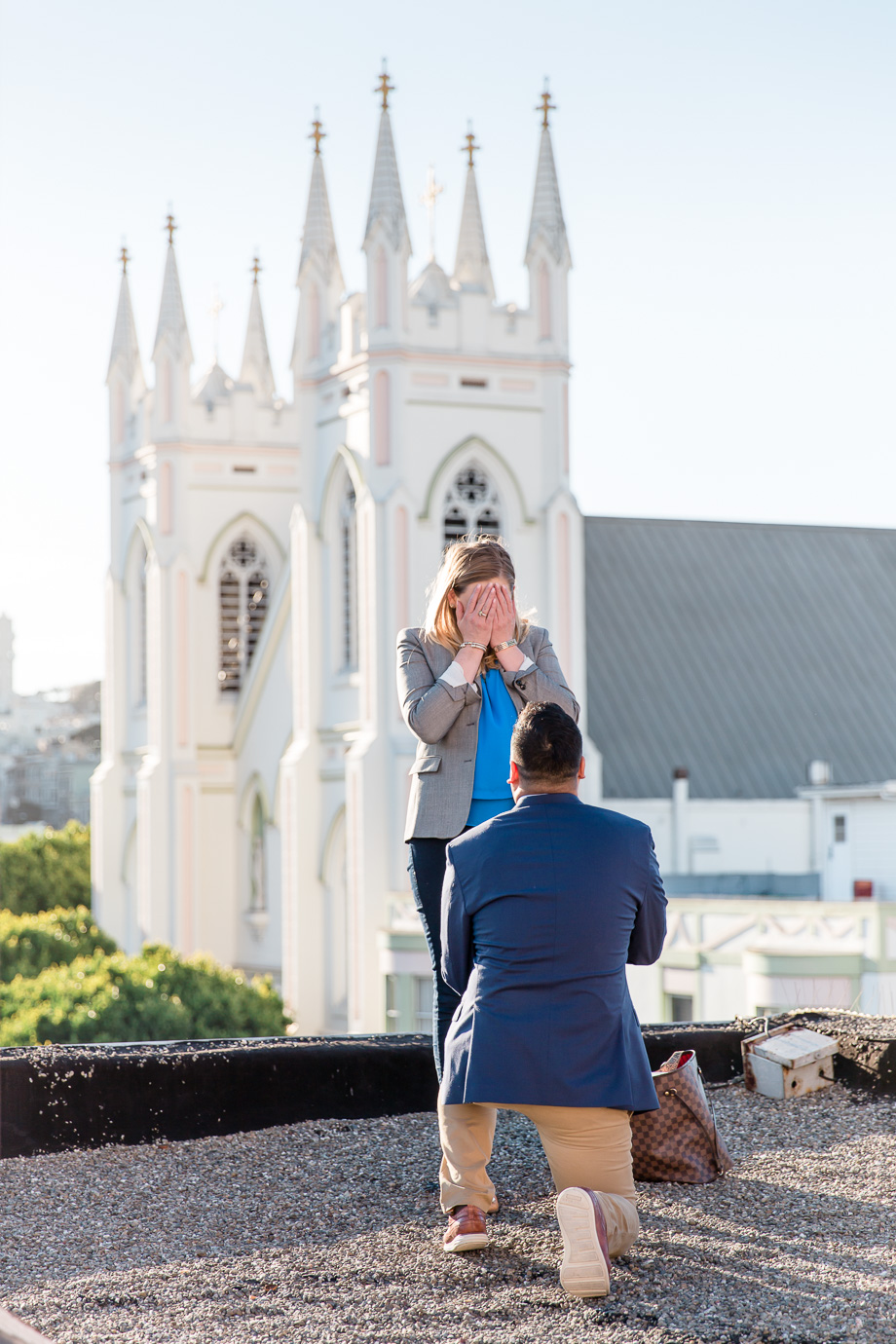 San Francisco rooftop surprise proposal photo in front of National Shrine of St Francis of Assisi church