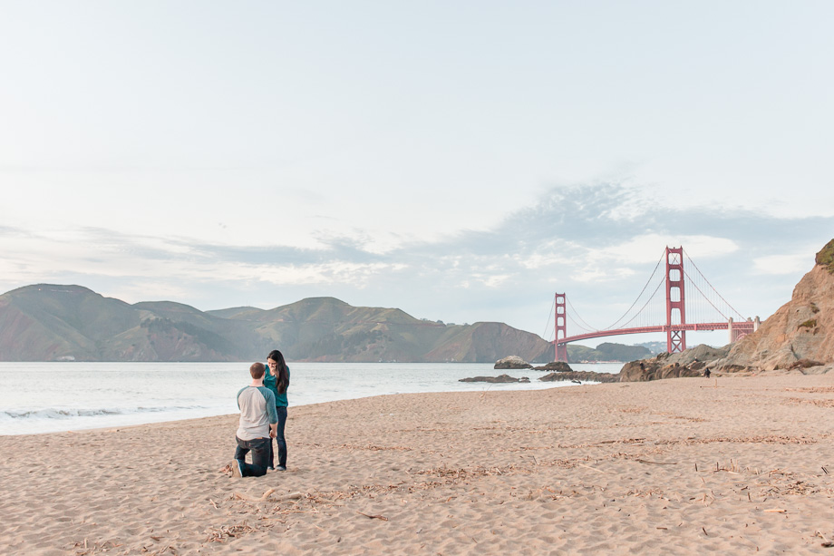surprise proposal Baker Beach wide angle clean background Golden Gate Bridge