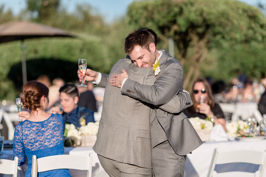 groom hugging his brother best man after the toast