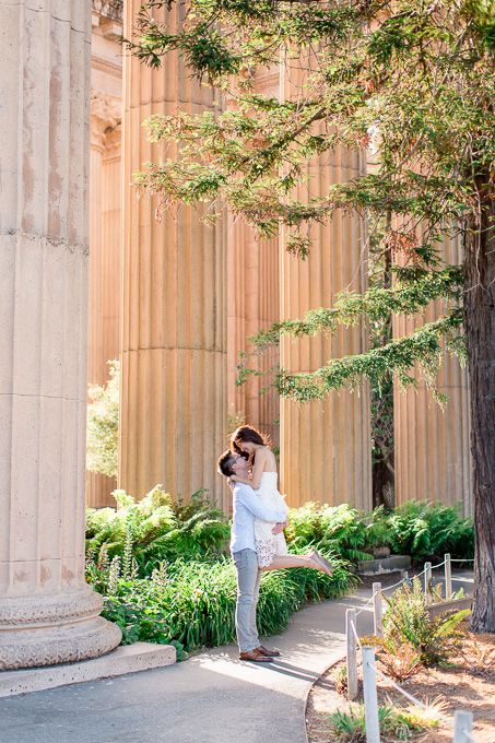 kissing in front of the Corinthian columns at Palace of fine arts