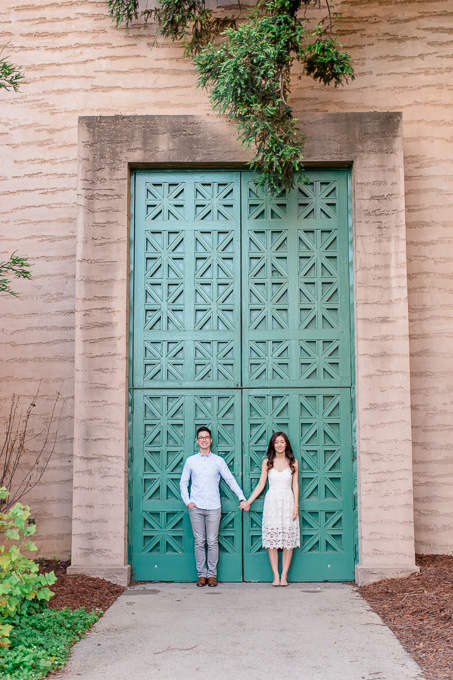 engagement photo in front of giant green doors Palace of Fine Arts