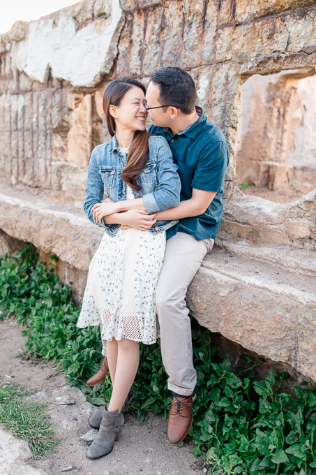 engagement photo with rustic backdrop