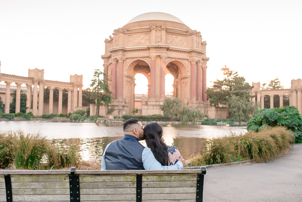 kiss on the forehead on a bench at the Palace of Fine Arts