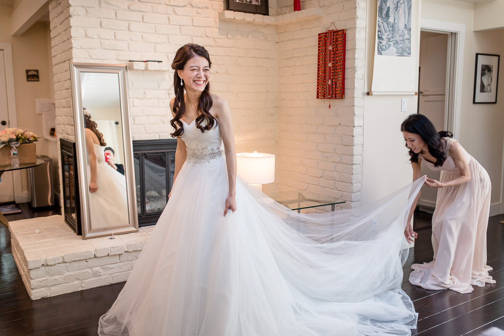 bridesmaid spread out bride's dress
