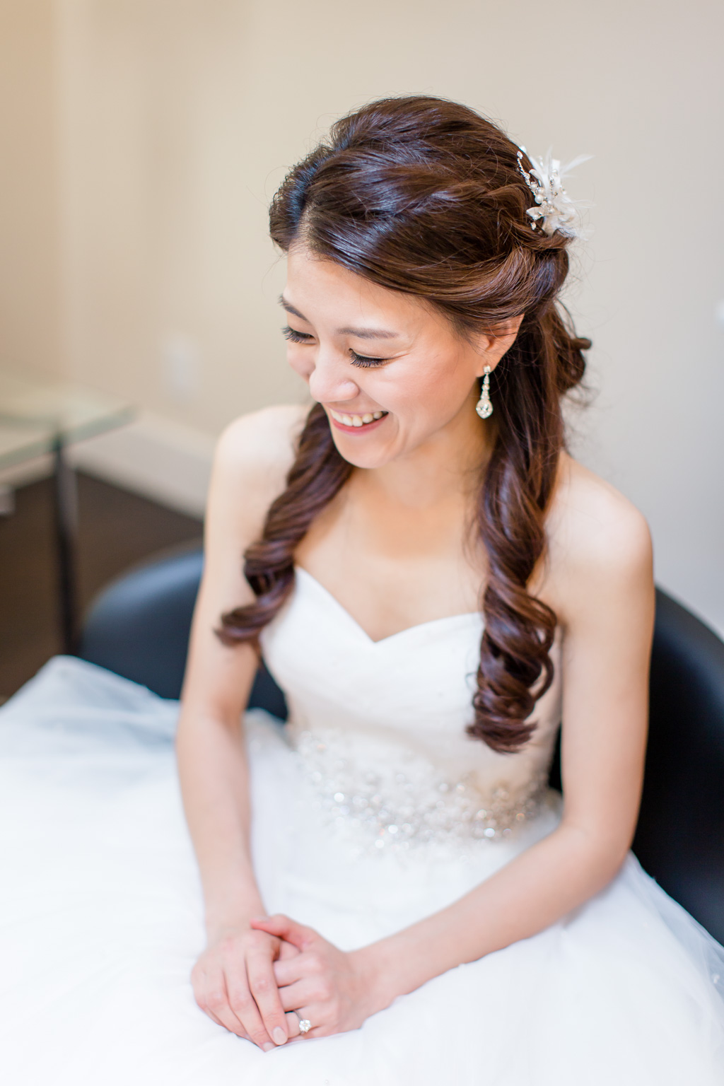 bride sitting and smiling before ceremony