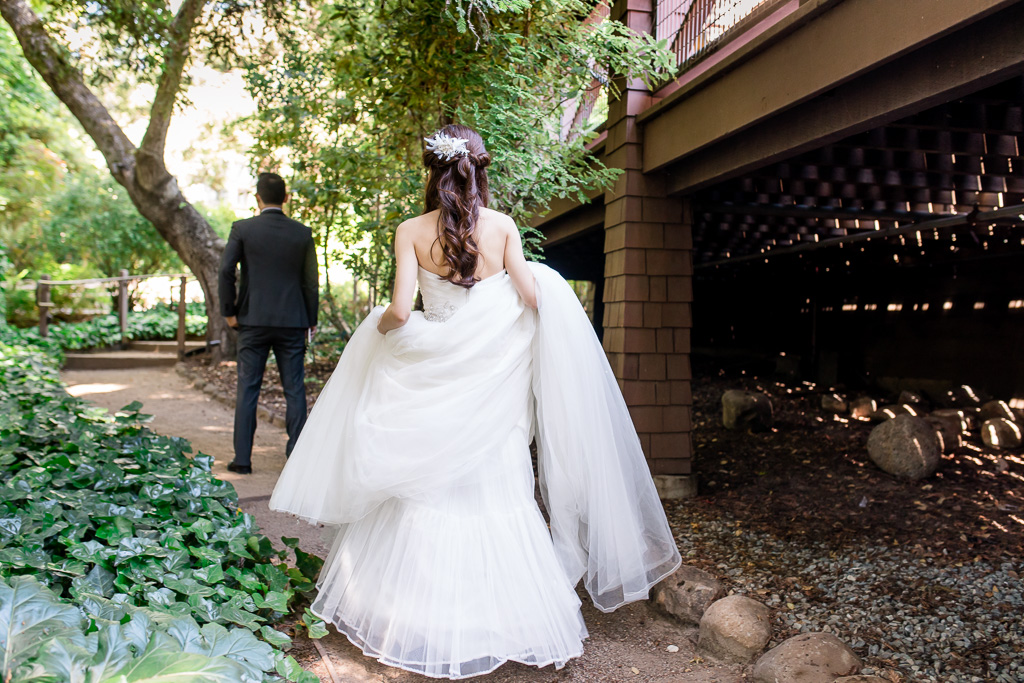 first look - bride walking up to groom