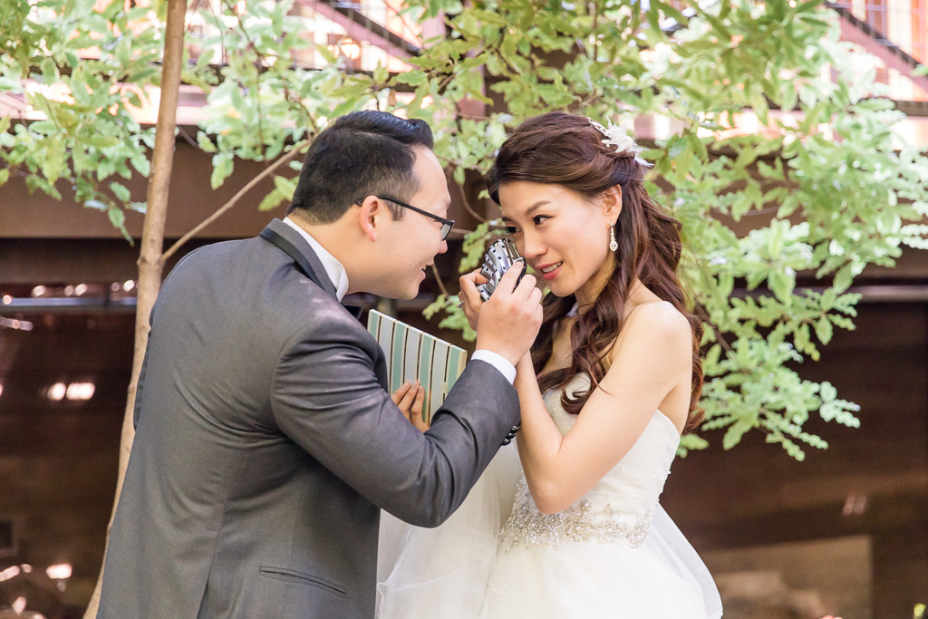 groom using handkerchief to wipe away bride's tears during emotional first look