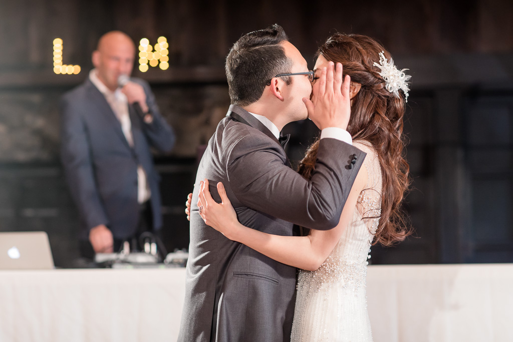 groom blocking their kiss from the audience