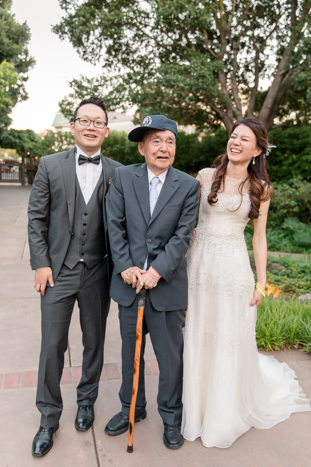 cute old grandpa posing with bride and groom