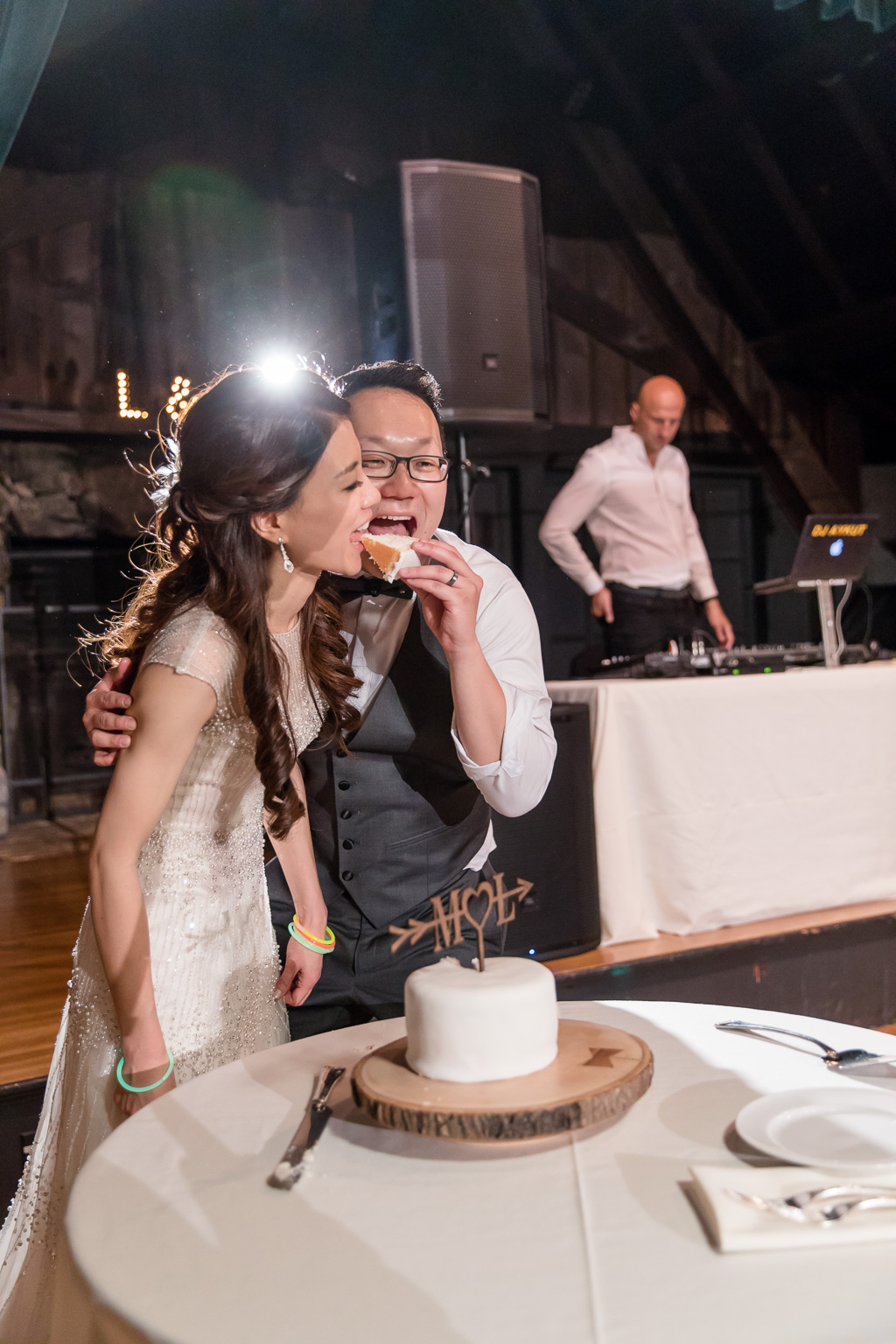 bride and groom sharing their first slice of cake as a married couple
