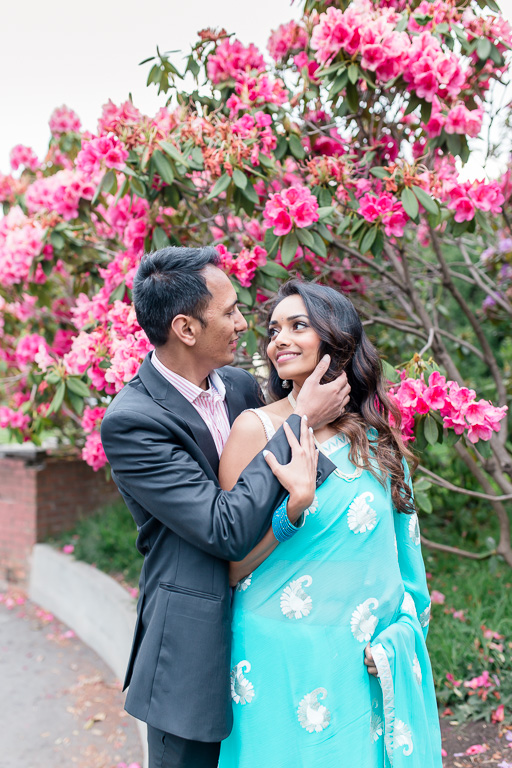 couple portrait in front of blooming flowers