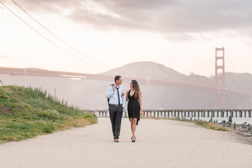 Couple walking in front of the Golden Gate Bridge