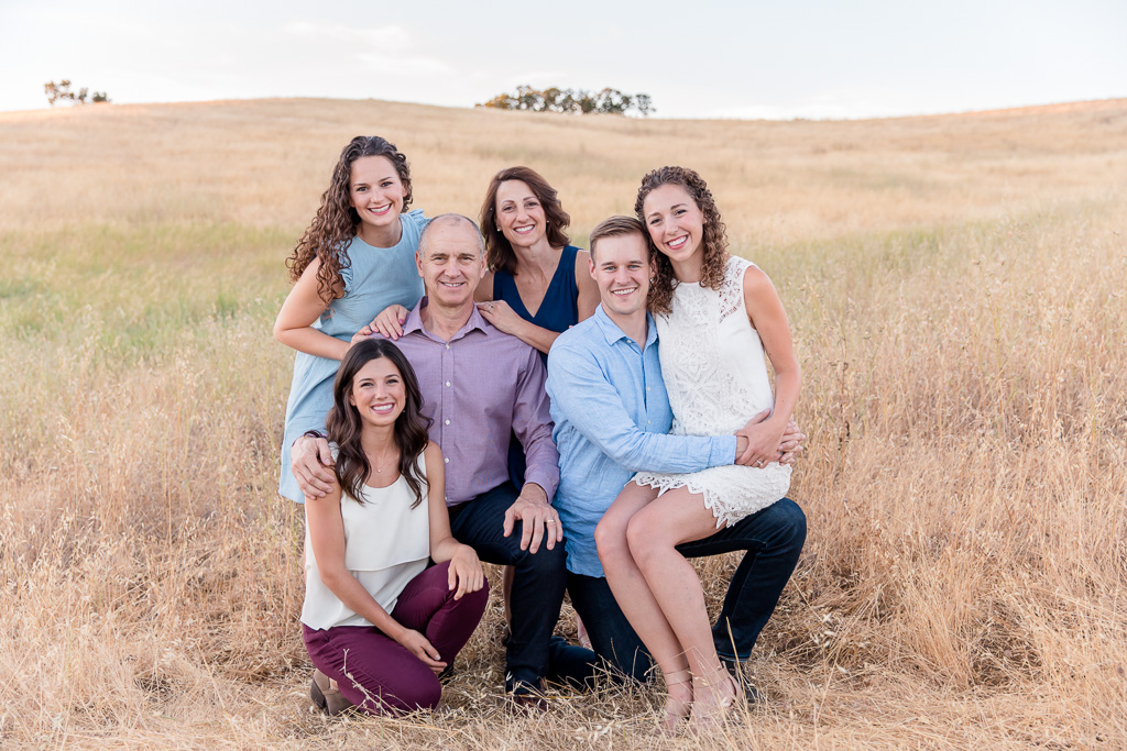 beautiful casual family photograph in a golden grassy field