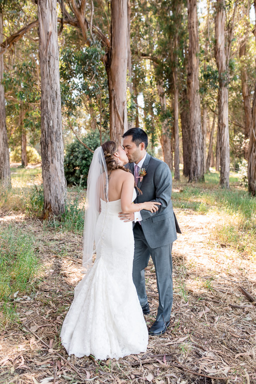 bride and groom kissing before ceremony after first look