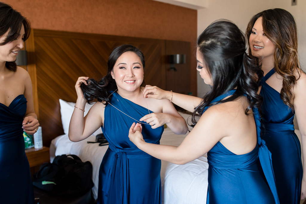 bridesmaids helping each other get ready