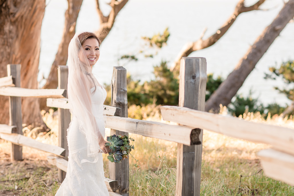 bridal photo next to a rustic fence at Coyote Point Marina