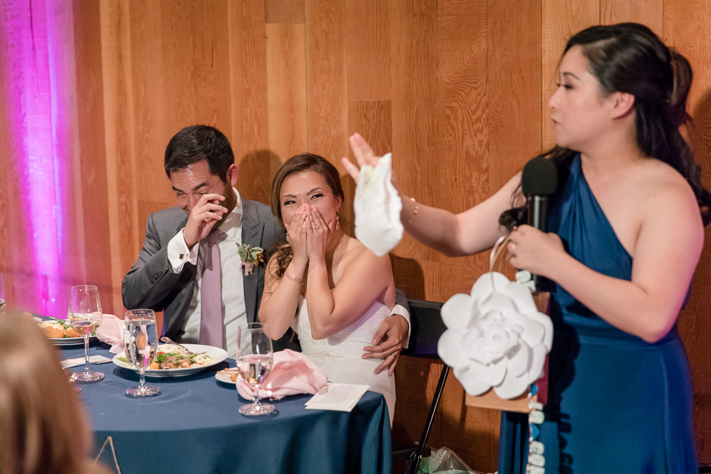 bridesmaid giving a funny speech and holding a diaper