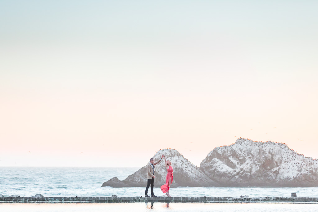 Sutro Baths twirl along the water's edge engagement picture