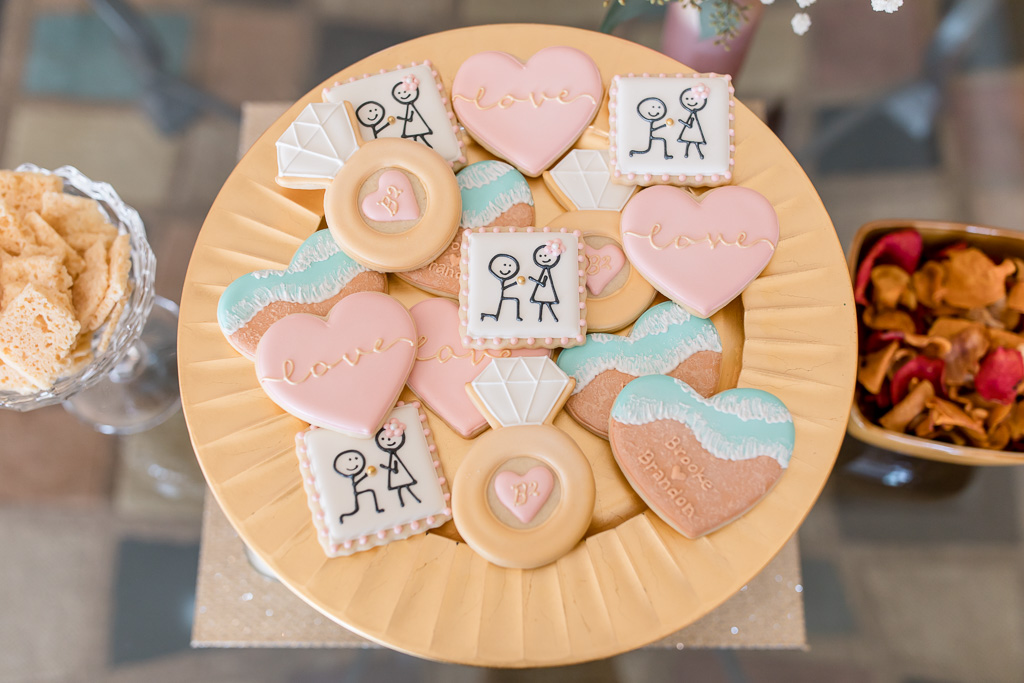 engagement party cookies with super cute drawings of a stick figure proposing