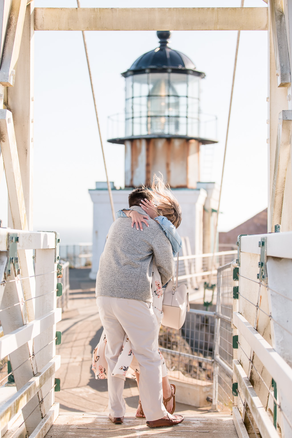 a kiss after they got engaged at the lighthouse