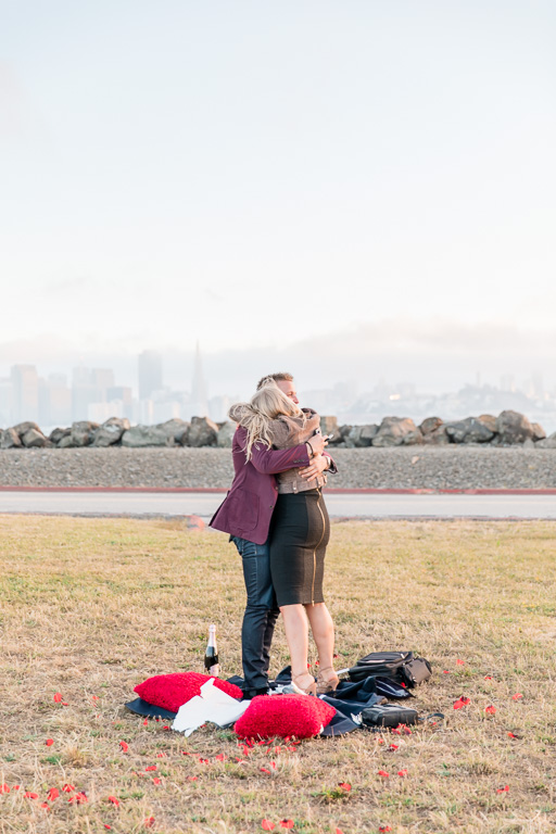 our couple is engaged in front of this stunning view of san francisco city skyline