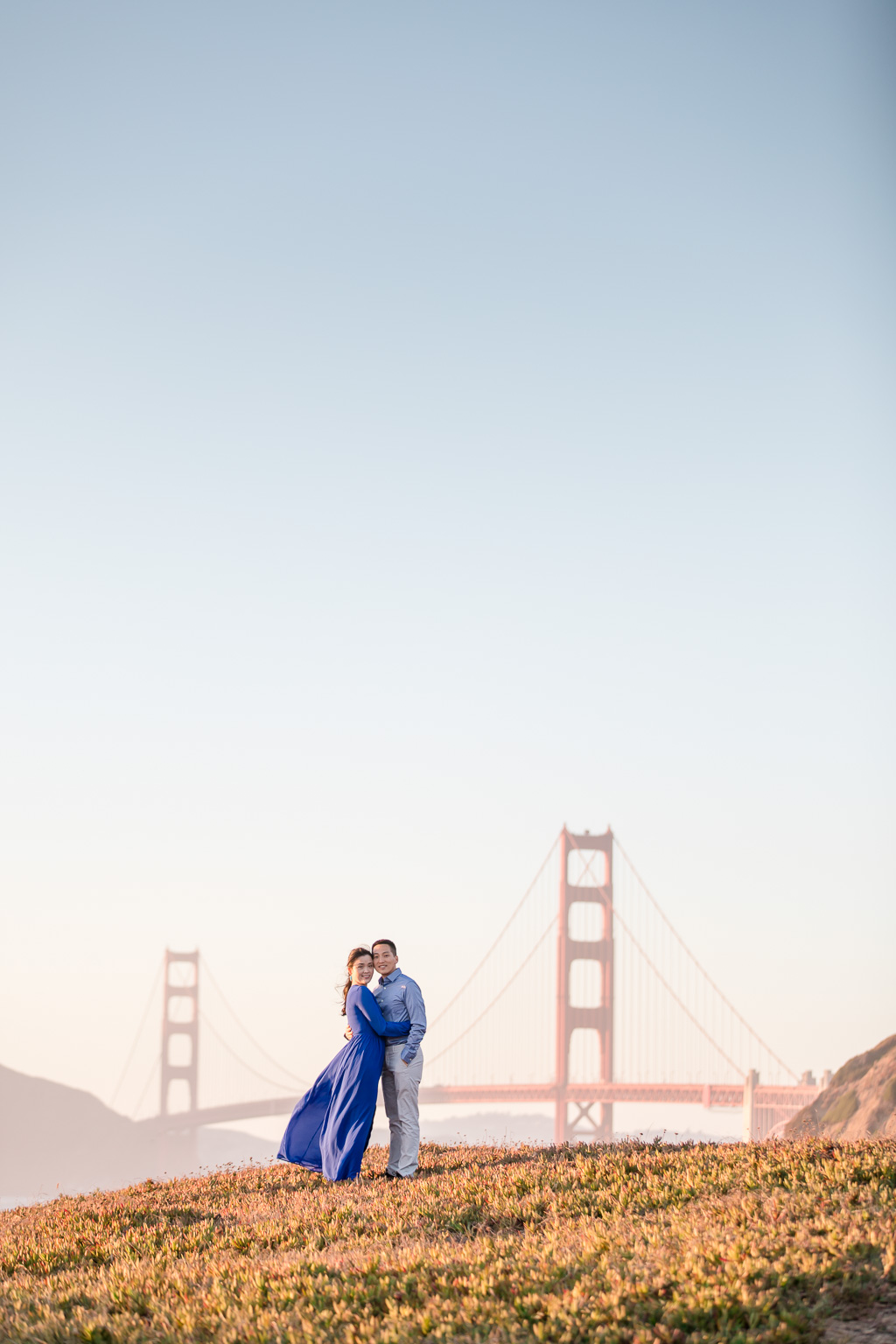 romantic sunset engagement photo in front of the golden gate bridge