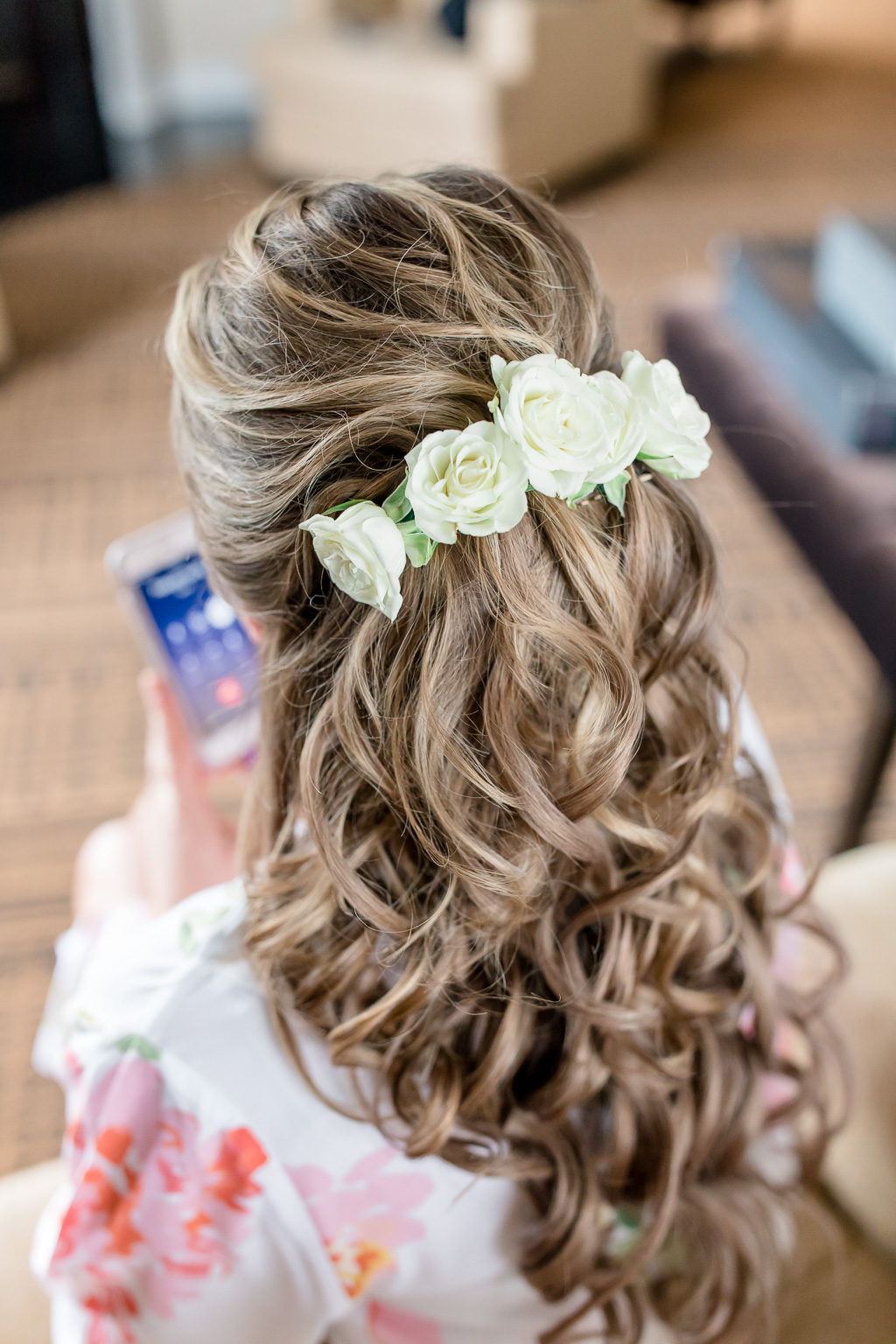 elegant and romantic half up half down bridal hair do with fresh roses