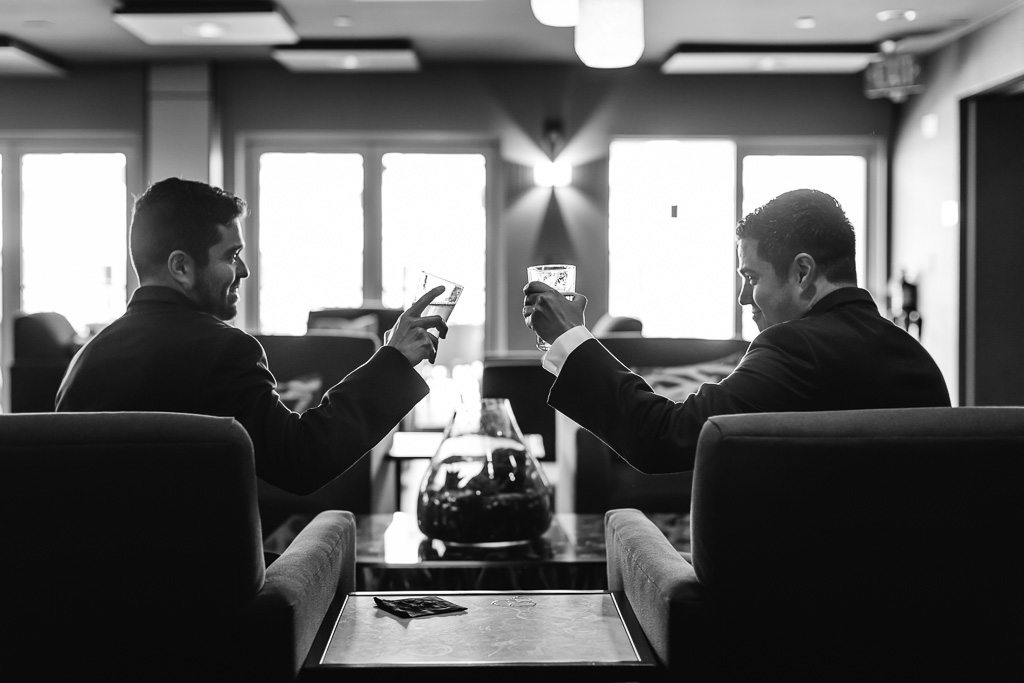 groom drinking at the bar with his best man