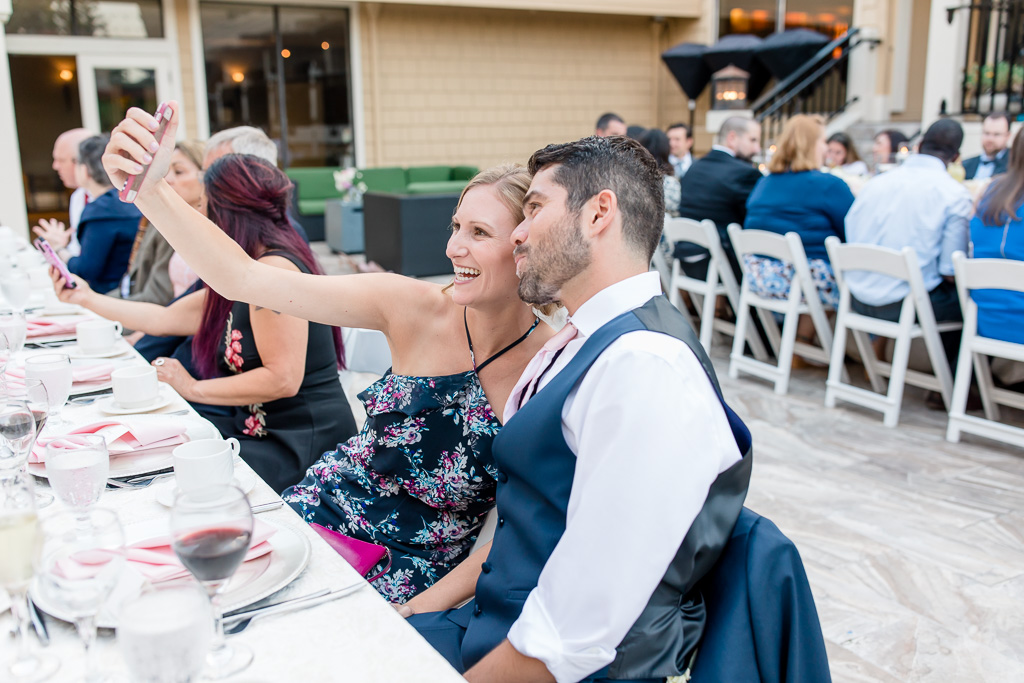wedding guests taking cute selfies at reception